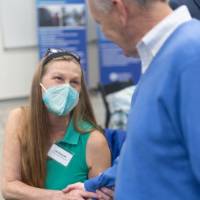 Faculty talking and shaking hands